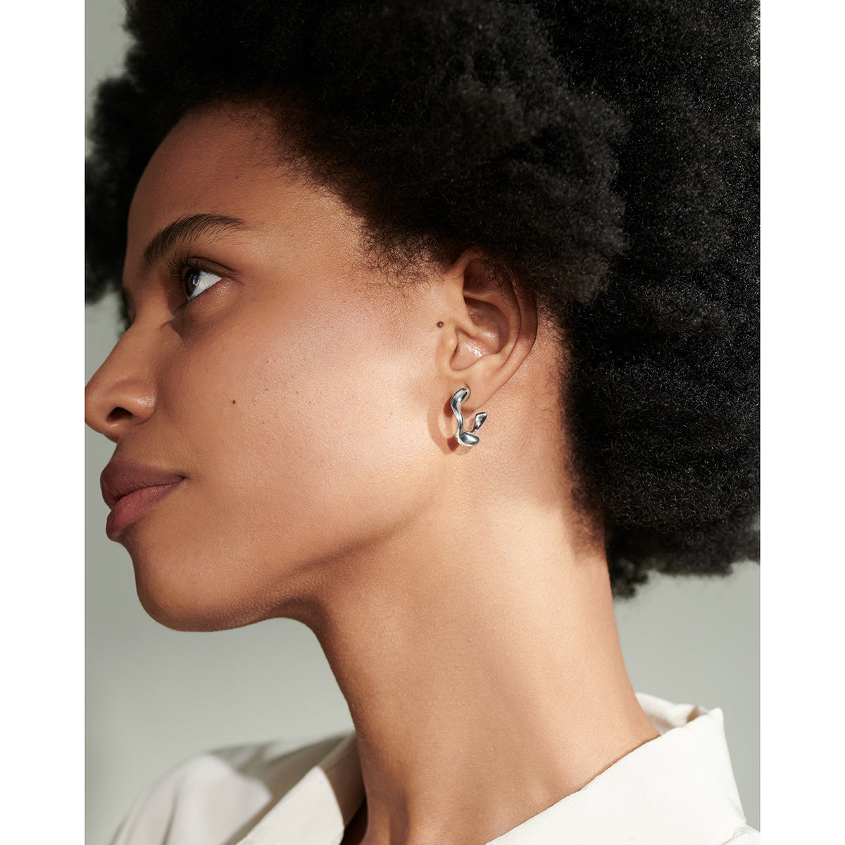 model wearing C.W. James recycled sterling silver Rainbow earrings