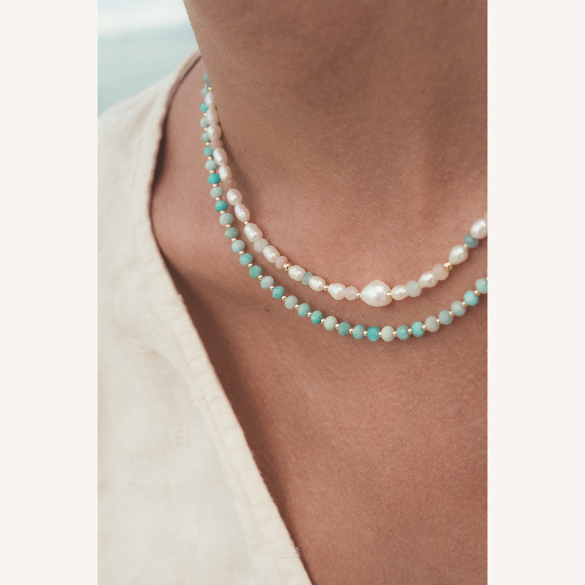 C.W.James Elodie Amazonite necklace and Harmony pearl necklace on model close up