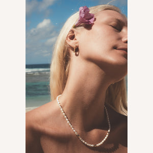 C.W. James Celeste pearl necklace on model at the beach