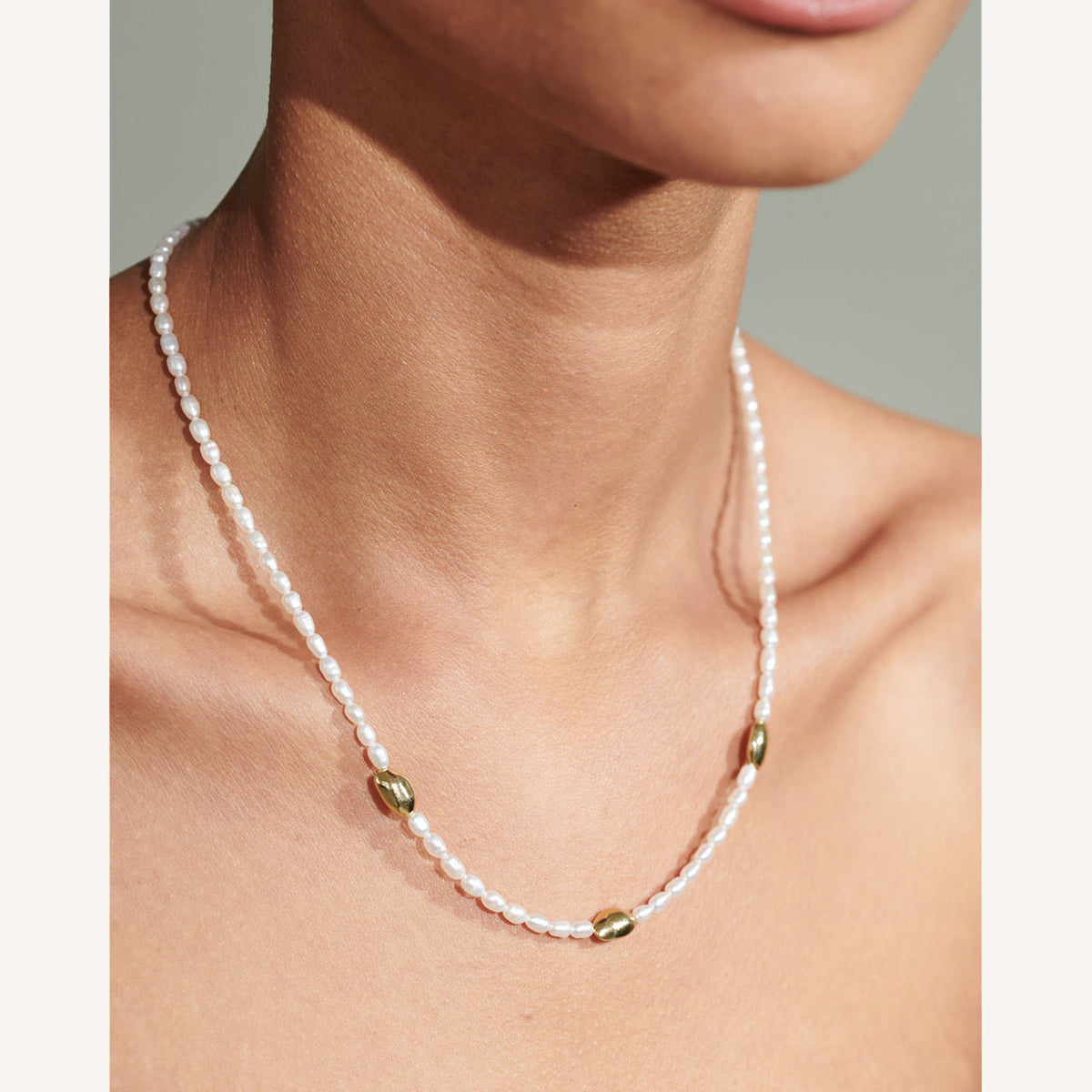 C.W. James Celeste pearl necklace on model close up